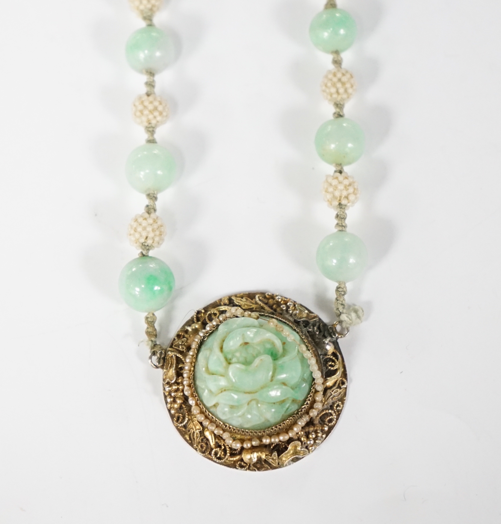 A Chinese late Qing jadeite and seed pearl choker necklace, carved jadeite and silver gilt pendant, 36cm